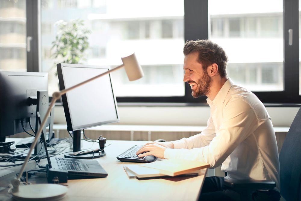 Executive with hands clasped, face out of frame